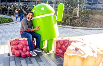 Caption: A photo of Omer hugging an Android statue.