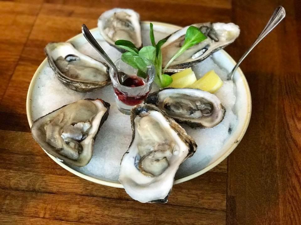 Caption: A photo of a plate of six oysters with ice and lemon from The Wild Son in New York, NY. (Local Guide Reine H.)