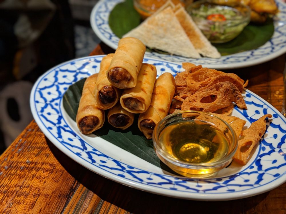 Caption: A photo of several spring rolls on a decorative plate from Thai Villa in New York, NY. (Local Guide Jaehoon A.)