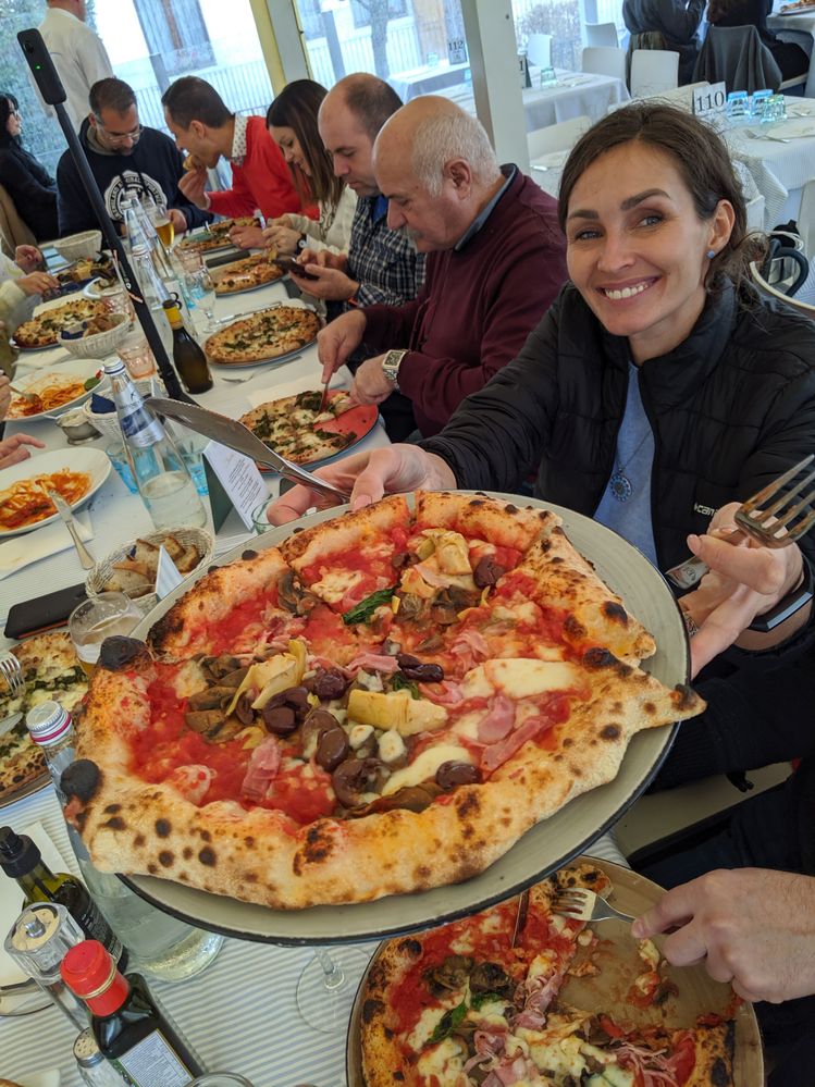Caption: Ukrainian Local Guide UaValentine is showing an Italian Pizza during the Wine Meet-up in Treviso - Italy - Photo Credit Local Guide @ermest