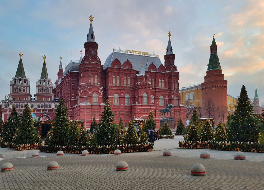 Caption: A photo of several decorated Christmas trees in front of the State Historical Museum in Moscow, Russia. (Local Guide Елена Черезова)