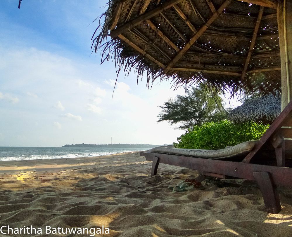 Caption: A low angle view of the beach, next to a folding chair and umbrella in Rekawa, Sri Lanka. (Local Guide @CharithaJB)