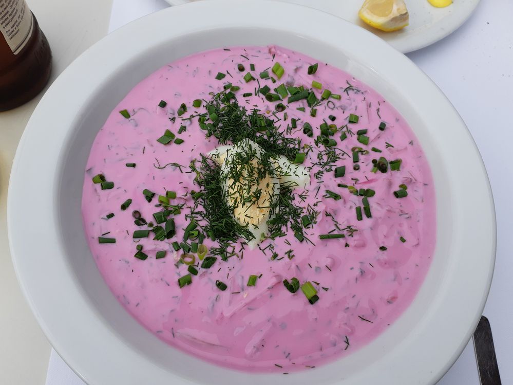 Caption: A photo of pink beetroot soup, garnished with boiled egg, chives, and dill. (Local Guide Joanna A)