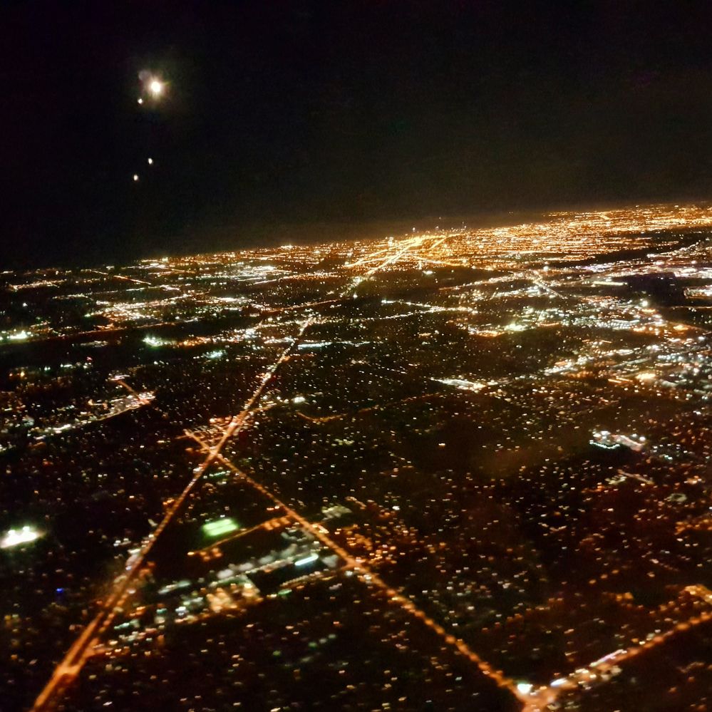 I love the view of any city in the evening, from an airplane. This is not a view of my own city though. I took this photo just after taking off, from the sky of Chicago, USA. Loved the view a lot.