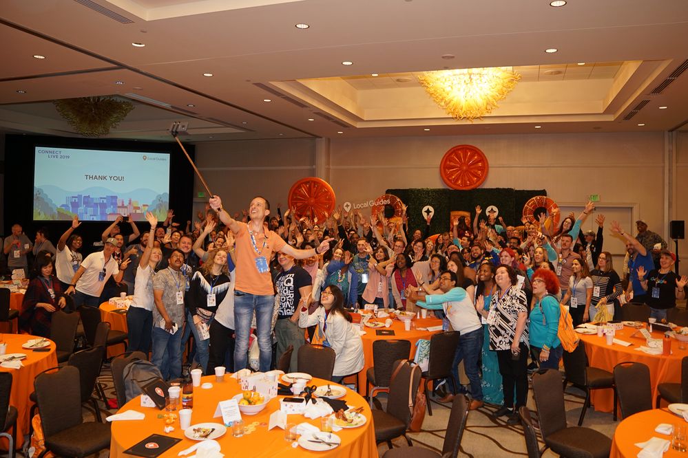 Caption: A photo of nearly 200 Local Guides taking a selfie together at Connect Live 2019.