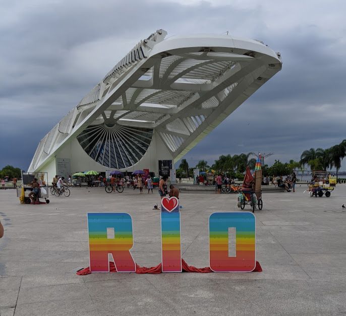 Caption: A photo of a rainbow-colored sign that reads “Rio” in front of the Museum of Tomorrow in Rio de Janeiro, Brazil. (Local Guide @AlexandreCampbell)