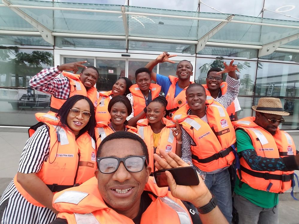 Caption: A selfie of Emeka and other Local Guides wearing life vests, and smiling and posing for the camera. (Courtesy of Local Guide @EmekaUlor)