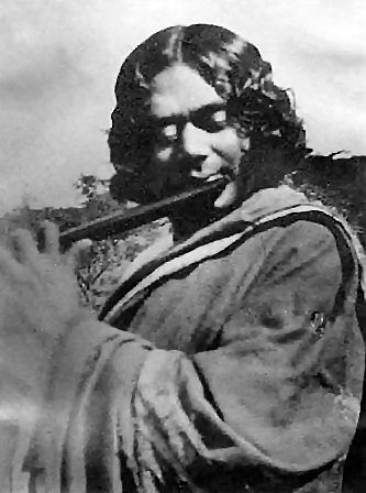 Kazi Nazrul Islam playing flute in 1926, Chittagong (Image source from web)