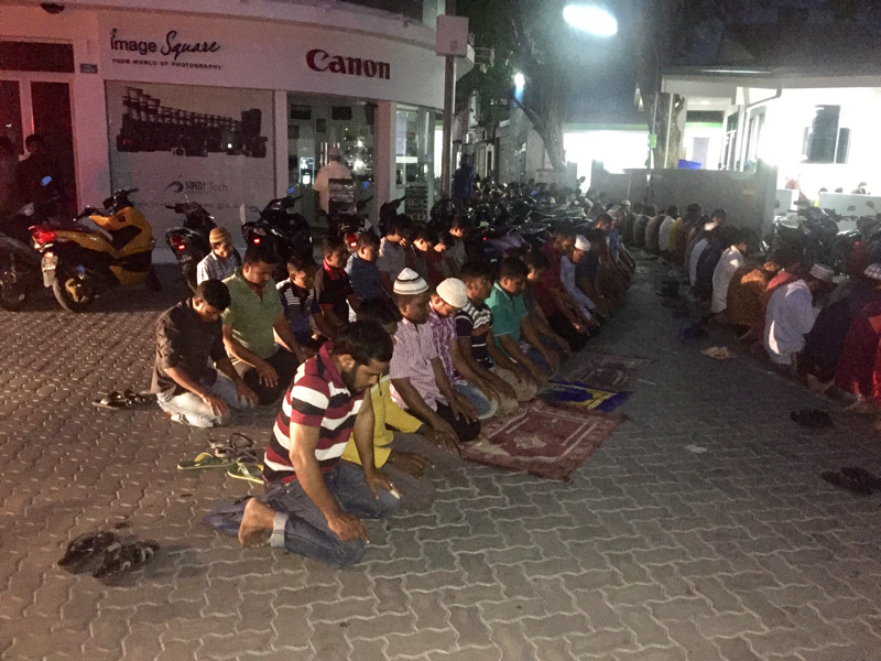 People praying on main Street Majeedee Magu in Capital City Male' Maldives