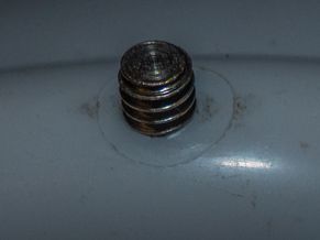 Tripod screw inserted through safety helmet