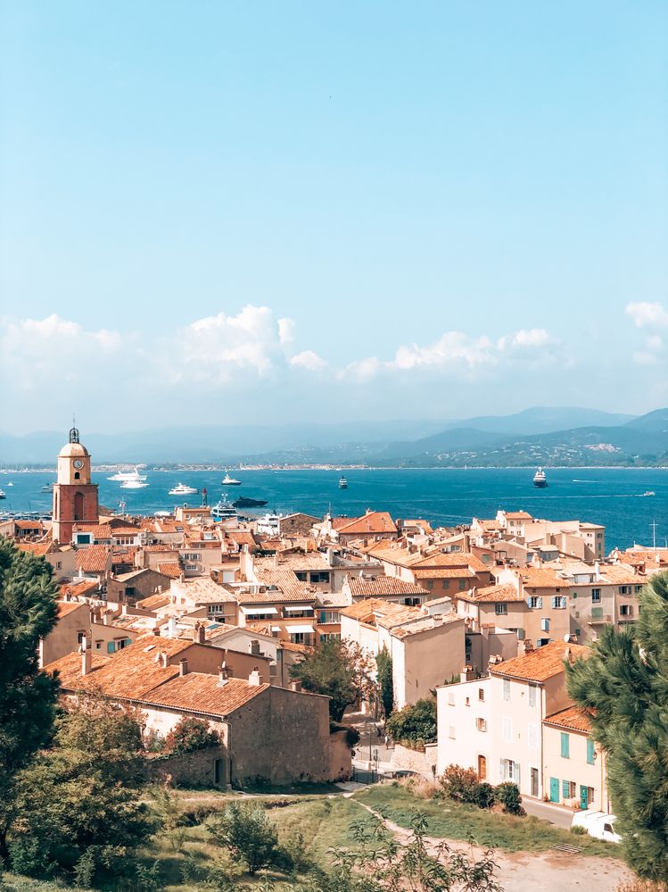 Caption: A photo of Saint-Tropez, standing on a hill overlooking the old town and the sea with yachts in it. (Local Guide DanniS)