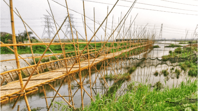Caption: This Bridge is built over  bamboo bridge
