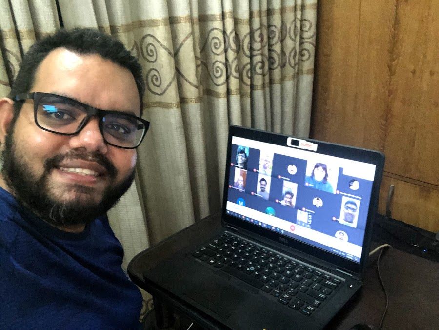 Caption: A photo of Local Guide @PavelSarwar taking a selfie with his laptop, on which we see other Local Guides attending his meet-up. (Local Guide @PavelSarwar).