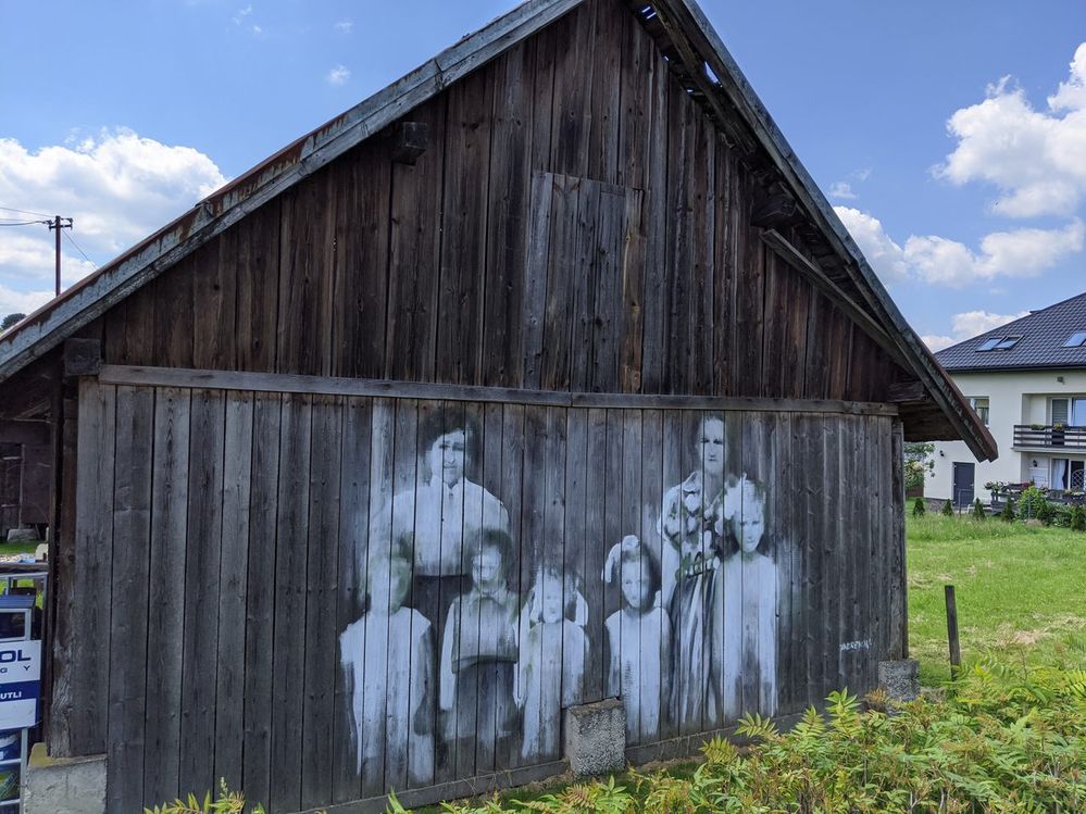 Barn wall with a painting presenting the family.